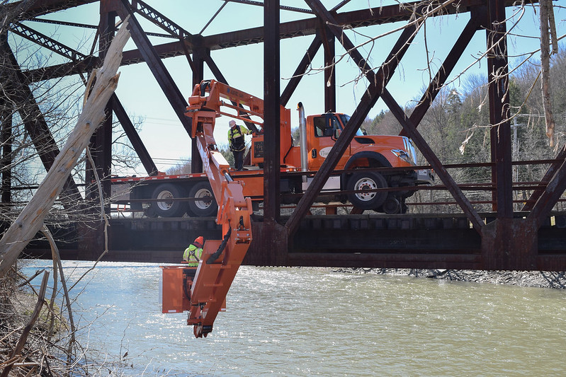 Construction workers and truck on bridge