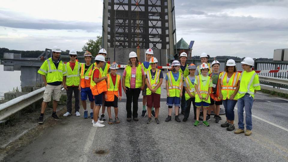 Students in hard hats on a bridge